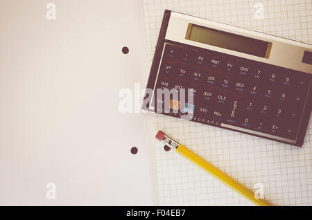 HP-12C Hewlett-Packard rpn financial calculator and yellow pencil on a paper notebook Stock Photo