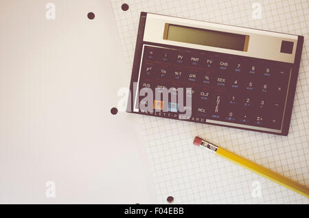 HP-12C Hewlett-Packard rpn financial calculator and yellow pencil on a paper notebook Stock Photo