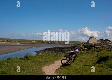 The coast path at  Newport Pembrokeshire . People sitting looking at the view Stock Photo