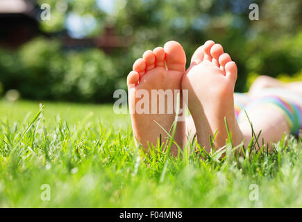 Little feet on the grass, close up photo Stock Photo