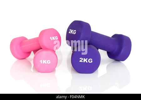 Purple and pink dumbbells isolated on white background. Weights for a fitness training. Stock Photo