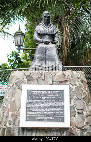 PANAMA CITY, Panama — A statue of Amelia Denis de Icaza (1836-1911), a Panamanian romantic poet and the first published Panamanian woman to publish her poetry. The statue sits on top of Ancon Hill overlooking Panama City. Ancon Hill is only 654-feet high but commands an impressive view out over the new and old sections of Panama City. With views out over both the Pacific Ocean and the entrance to the Panama Canal, the area was historically where the administration of the Panama Canal was centered and now has a mix of high-end residences and government departments. Stock Photo