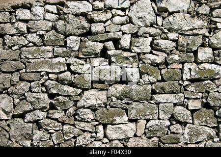 Rustic stone wall with strong gaps between stones Stock Photo