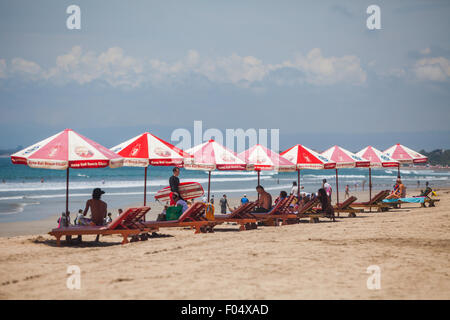 Sunshades for visitors on Kuta Beach, Badung, Bali, Indonesia. Stock Photo