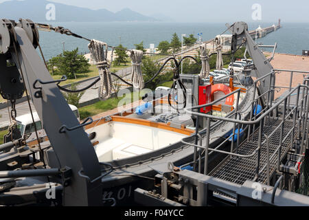 A lifeboat on the rear of a cargo ship Stock Photo