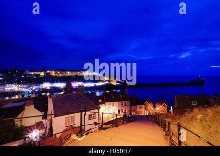 View from the top of the top of the 199 steps of St Mary the Virgin Church, looking down over Whitby at night Stock Photo