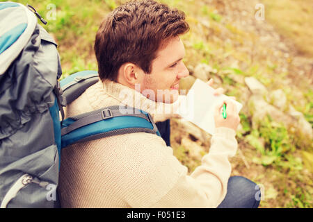 smiling man with backpack hiking Stock Photo