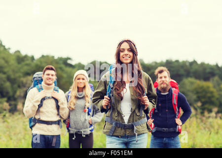 group of smiling friends with backpacks hiking Stock Photo