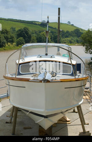 Fairey Huntsman, Classic power boat from 1960's. motor boat on stilts out of the water for repaint. Stock Photo