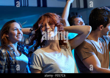 happy friends dancing at night club Stock Photo