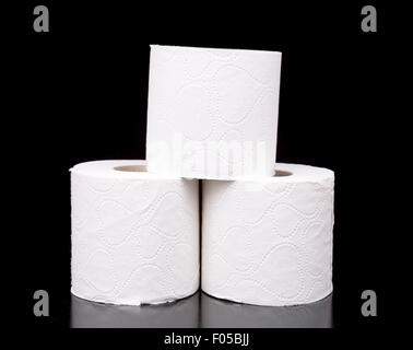 Three Rolls of Toilet Paper with black background. Stock Photo
