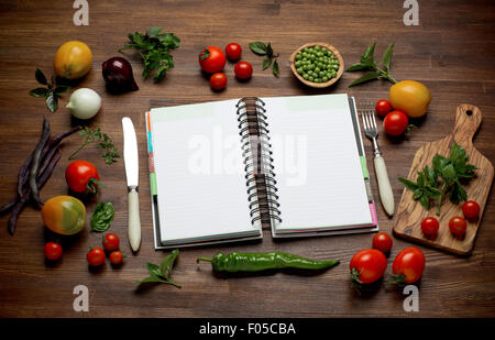 Fresh Organic Vegetables and Spices on a Wooden Background and Paper for Notes. Open Notebook. Diet. Dieting Stock Photo