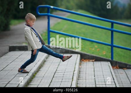 little boy jumping on the stairs Stock Photo