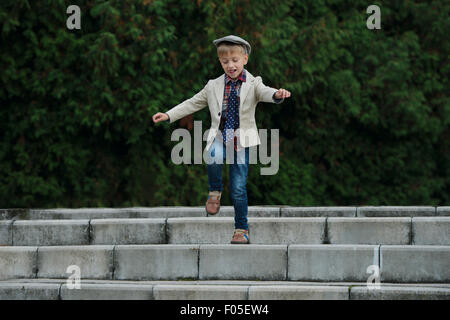 little boy jumping on the stairs Stock Photo