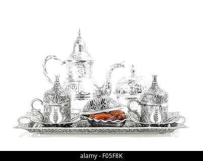 Silver tableware and dates. Oriental hospitality concept with tea or coffee cups Stock Photo