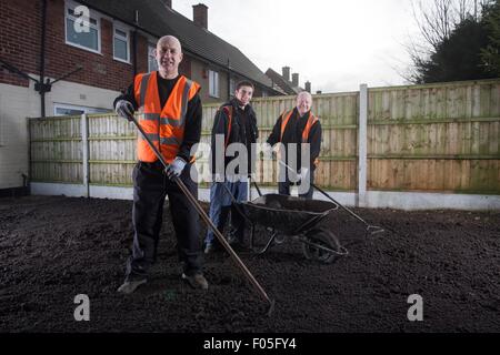 Gardeners at work in the back yard of a terrace. Stock Photo
