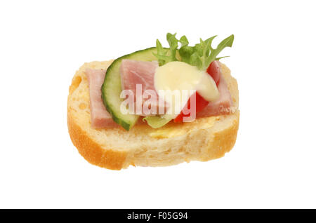 Canape, slice of French bread with ham, tomato,lettuce, cucumber and salad cream isolated against white Stock Photo