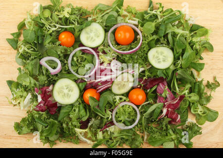 Mixed salad on a wooden board viewed from above Stock Photo