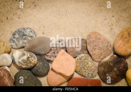 pebbles composition on sand  background Stock Photo