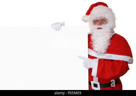 Santa Claus pointing with finger on Christmas at empty banner with copyspace for your own text Stock Photo