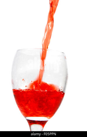 Red wine pouring in a glass isolated on a white background Stock Photo