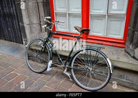 Parked bike on a lonely street in Bruges, Belgium Stock Photo