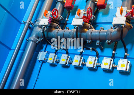 Plumbing system controls mounted on a stairwell wall in a LEED certified building Stock Photo