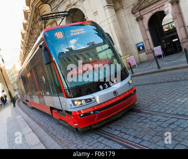 Red tram in the old town side. The Prague tramway (streetcar) network is the largest such network in Stock Photo