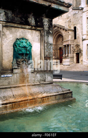 France, Bouches du Rhone, Arles, Fountain at Place de la Republique and Saint Trophime Cathedral in Background. Stock Photo