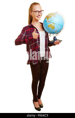 Happy young woman as teacher holding thumb up and carrying a globe Stock Photo