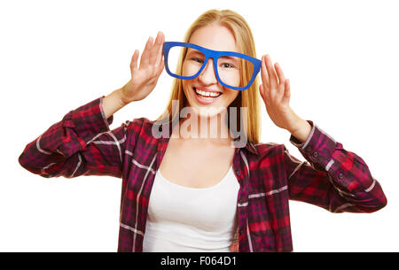Happy blonde woman holding fake glasses in front of her eyes Stock Photo