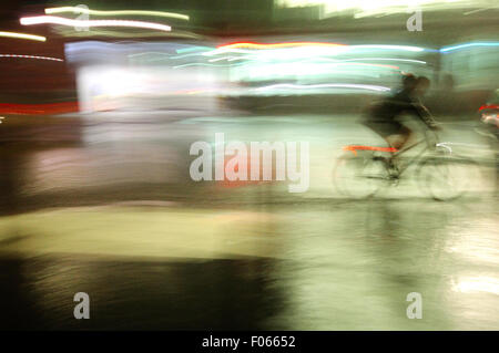 Germany, Berlin, Man on Bicycle in Rain Stock Photo