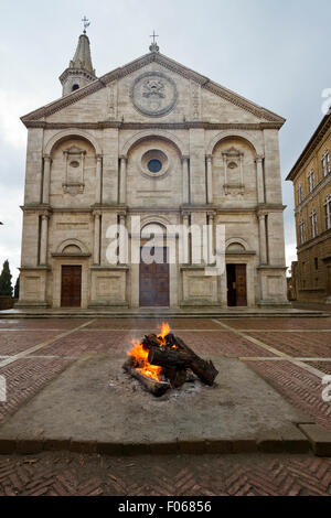 Bonfire in front of Santa Maria Assunta Duomo (Cathedral) in Pienza main square, Tuscany, Italy. Stock Photo