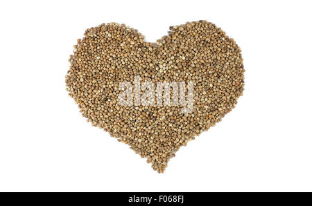 Hemp seeds in a heart shape, isolated on a white background Stock Photo