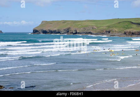 North Cornwall - Polzeath - surfers beach - white topped breakers rolling in - blue green sea - Pentire Point - sunlight Stock Photo