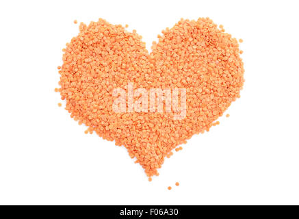 Red lentils in a heart shape, isolated on a white background Stock Photo
