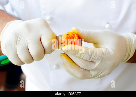 Chef Carving Carrot Stock Photo