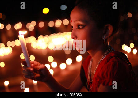 Dhaka, Bangladesh. 8th Aug, 2015.  A girl holds a candle at a celebration ahead of the August 9 International Day of the World's Indigenous Peoples in Dhaka on August 8, 2015. This year United Ntions make slogan for ths day is ''Ensuring indigenous peoples' health and well-being' Credit:  Zakir Hossain Chowdhury/ZUMA Wire/Alamy Live News Stock Photo