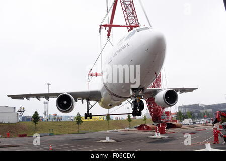 An Airbus plane type A 300 is lifted by a 60-metre-high crane onto a parking area at the airport Cologne-Bonn, Germany, 8 August 2015. The Airbus A300 ZERO-G was used until 2014 by the German national aeronautics and space research centre 'DLR' to test zero gravity, in autumn it will be used as an interactive airplane in the museum. Photo: Horst Galuschka - NO WIRE SERVICE - Stock Photo