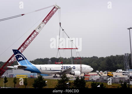 An Airbus A 300 is lifted onto a parking area using a 60-metre-high crane at Cologne/Bonn Airport, Germany, 8 August 2015. The Airbus A300 ZERO-G was used by the German Aerospace Center (DLR) as a parabolic flight aircraft to simulate zero gravity, until 2014. From autumn it will be used as an interactive museum aircraft. PHOTO: HORST GALUSCHKA - NO WIRE SERVICE - Stock Photo