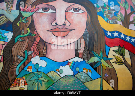 Beautiful graffiti of young woman with houses, trees and flag from Venezuela. Downtown Caracas 2015. Stock Photo
