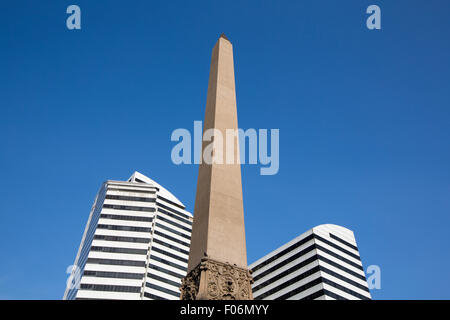 Plaza Francia in Altamira disctrict in Caracas. Obelisk in between two modern white buildings against a blue sky. Venezuela 2015 Stock Photo