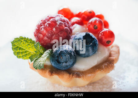 Close up to mini tart stuffed with vanilla pudding and berry fruits,selective focus Stock Photo