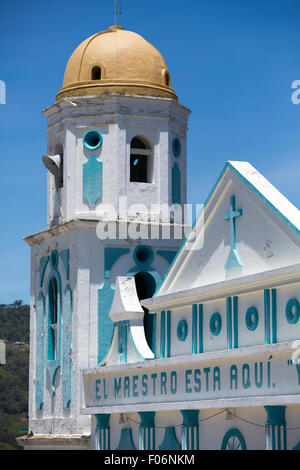 Little small blue and white small colonial church against a clear blue sky with a cross, basic decoration and letters Stock Photo