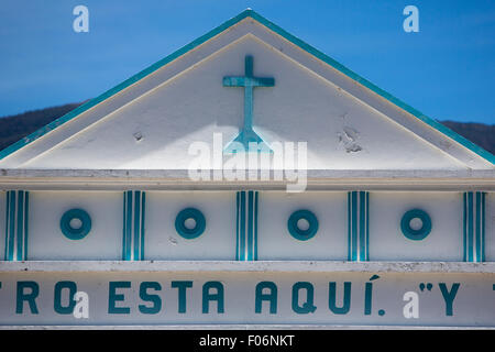 Little small blue and white small colonial church against a clear blue sky with a cross, basic decoration and letters Stock Photo