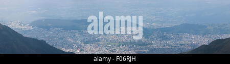 Spectacular panoramic view of Quito from the mountain, the capital of Ecuador in the background. Stock Photo