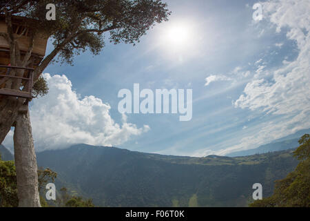 View of the volcano Tungurahua under the clouds from La Casa del Arbol, a popular viewing spot in Banos, Ecuador Stock Photo