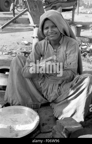 untouchable woman in india preparing food brian mcguire Stock Photo