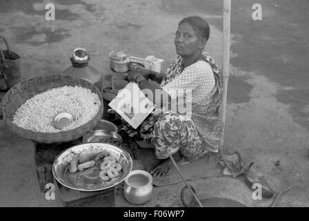 woman selling wares in street brian mcguire Stock Photo