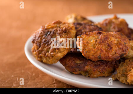 Roasted meatball on a white plate with brown background Stock Photo